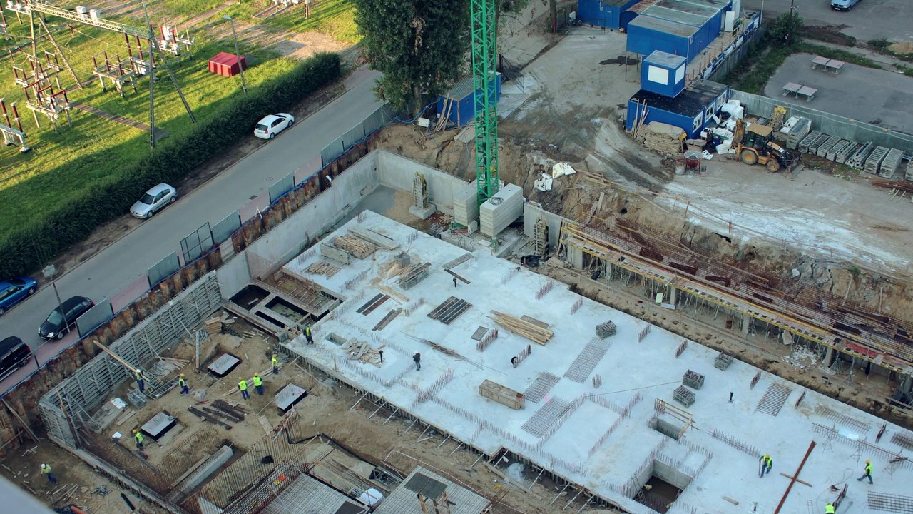 Active construction site with crane and foundation work